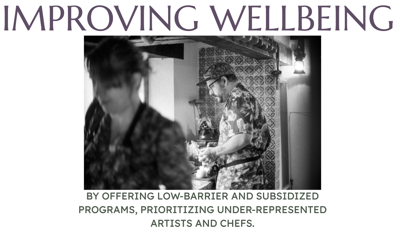 Untitled a black and white image of two chefs one in focus one blurry/in the foreground - both in floral aprons - tiles in the kitchen which is rustic - both at work